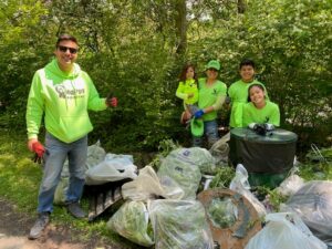 Volunteers pose proudly with collected trash