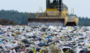 tractor shoveling waste