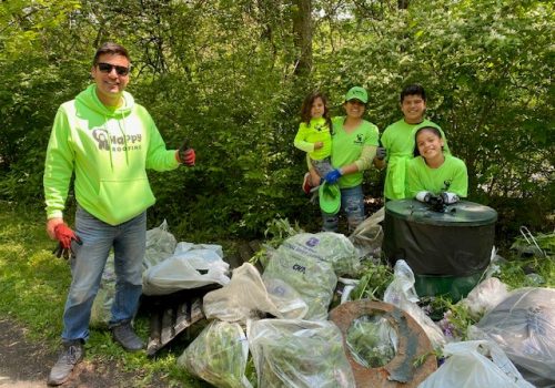 Volunteers pose proudly with collected trash